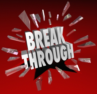 The word Breakthrough breaking through glass to symbolize discov